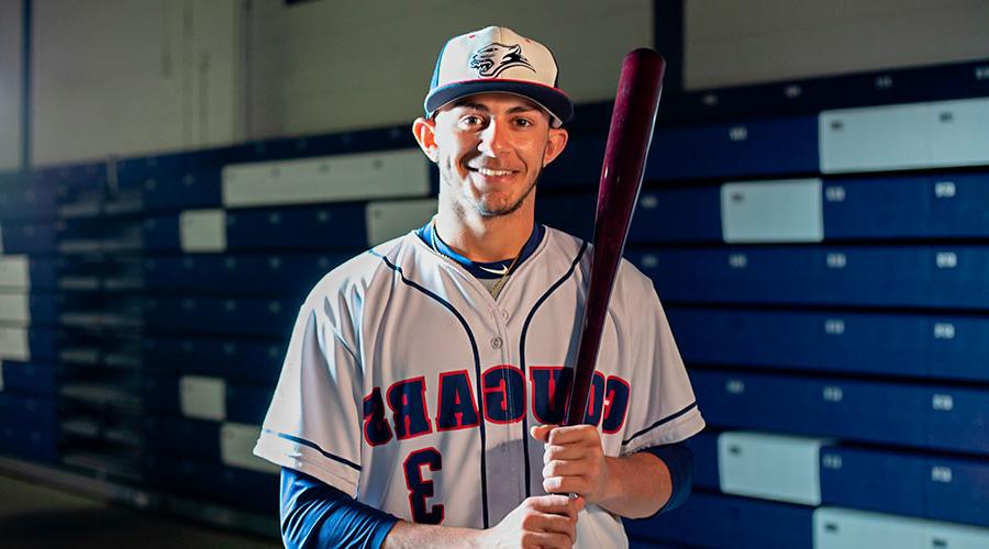  Cougars baseball player posing with a bat